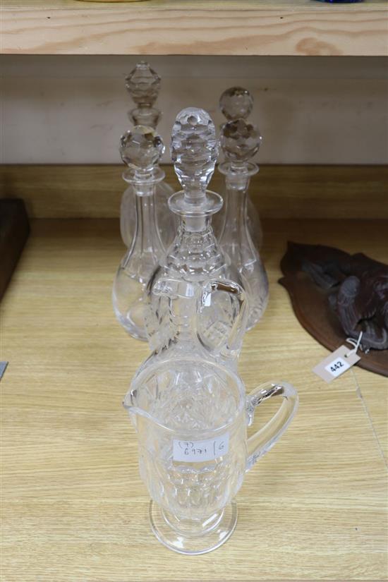 Five cut glass decanters, a claret jug and another jug